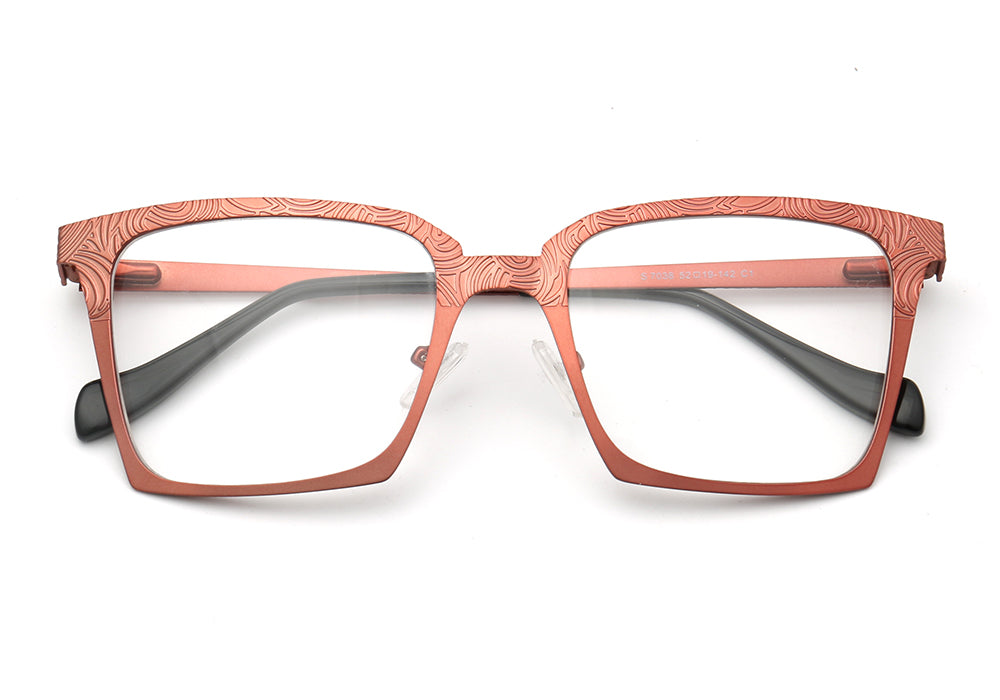 A pair of peach colored stainless steel eyeglass frames