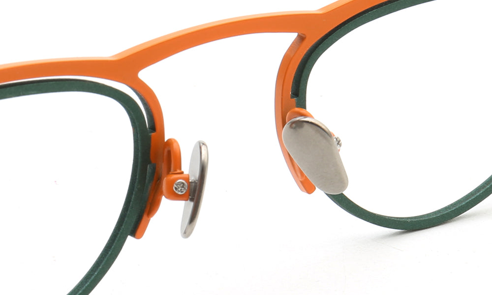 Nose pads of orange and green flat top titanium glasses