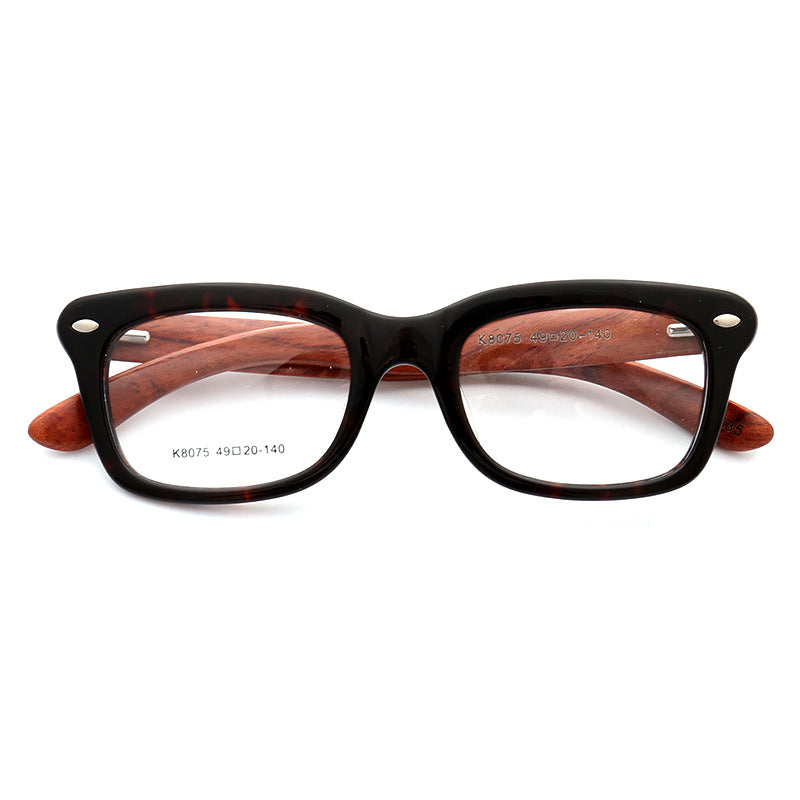 A pair of tortoise patterned wooden full rim glasses