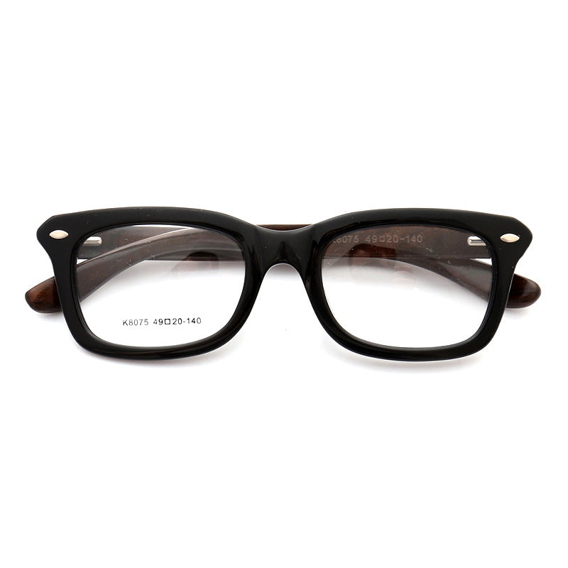 A pair of black full rim wooden eyeglass frames