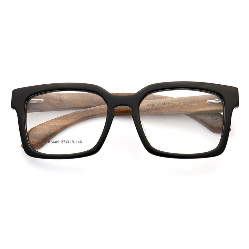 A pair of black full rim wooden eyeglass frames