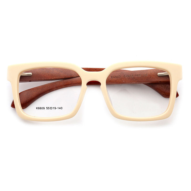 A pair of cream colored full rim wooden eyeglasses