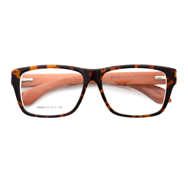 A pair of tortoise shell wooden eyeglass frames